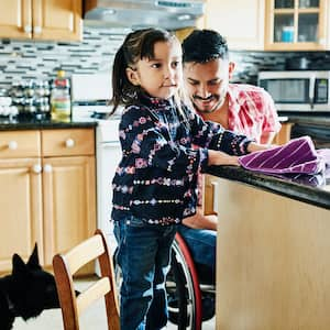 Father and daughter cleaning kitchen