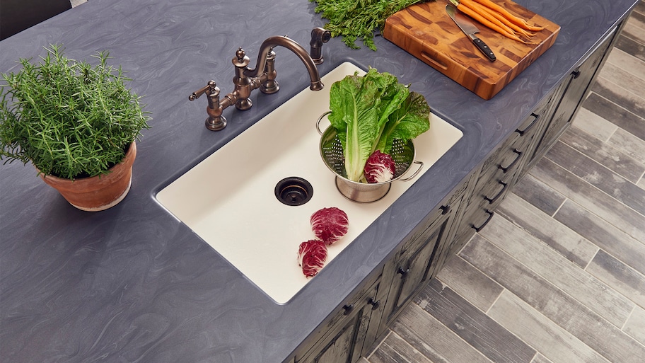 Dark Corian counter around kitchen sink