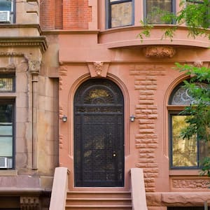 A front door in a brownstone house