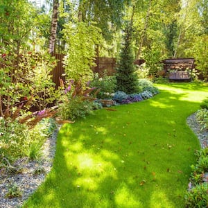 A backyard of a house with a lush garden