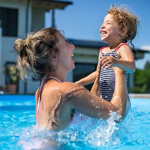 mother and child playing in the swimming pool