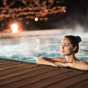 woman in a heated swimming pool at night