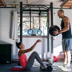 A woman exercising with personal trainer