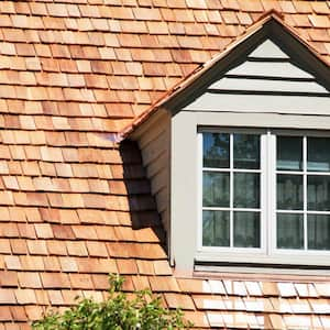 A dormer house with a cedar shake roof