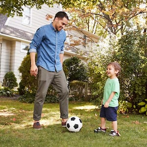 Father and son playing in yard