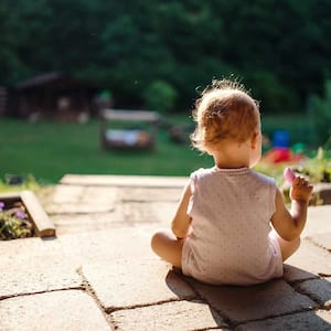 Child sitting in backyard