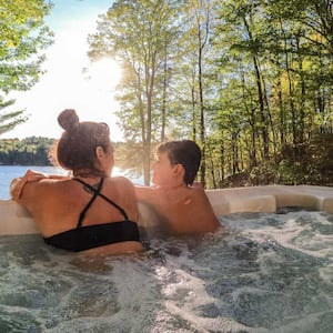 Boy and his mom relaxing in a cottage hot tub