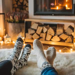 two people sitting by the fire