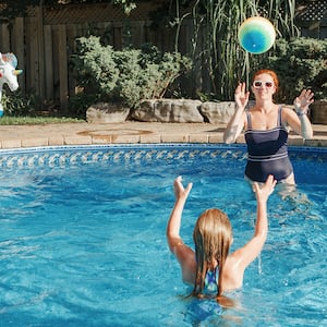 woman and children playing in swimming pool