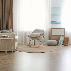 A view of a living room with herringbone laminate flooring