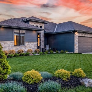 A luxury house with lawn garden at dusk