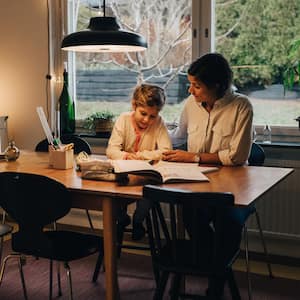 A mother assisting her daughter with homework 