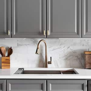 A view of a kitchen with gray cabinets