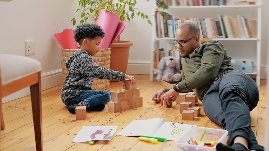 Dad and son build blocks on hardwood floors