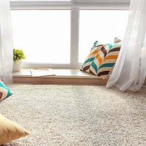 Carpeted reading nook with throw pillows