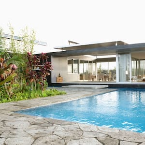 Natural stone patio with a modern house in the background