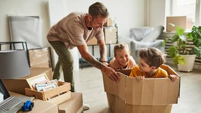 A father playing with his sons while packing their house