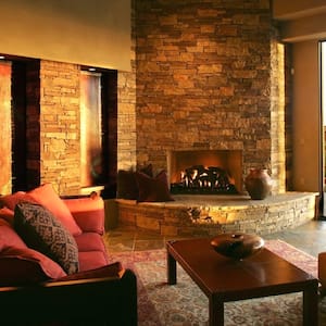 fireplace in living room opening up to a desert scene