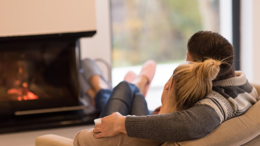 Young couple in front of fireplace