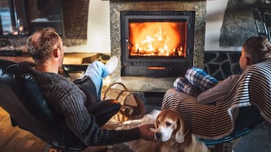 Father with son sitting near fireplace