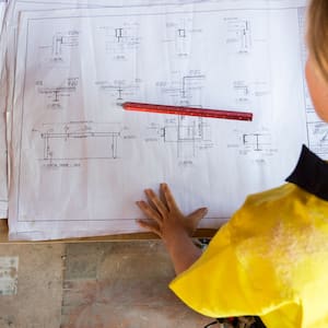 A female contractor looking at site plans