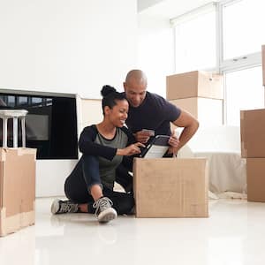 A couple surrounded by moving boxes