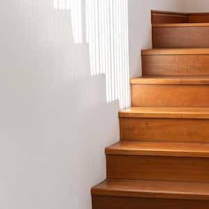 A black steel stair railing on a wooden staircase