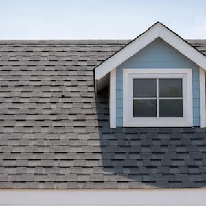 blue house with asphalt shingle roof 