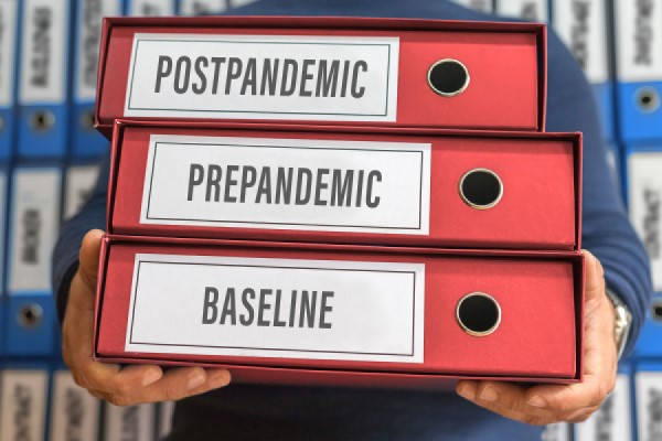 A stack of binders with labels for "post-pandemic," "pre-pandemic," and "baseline"