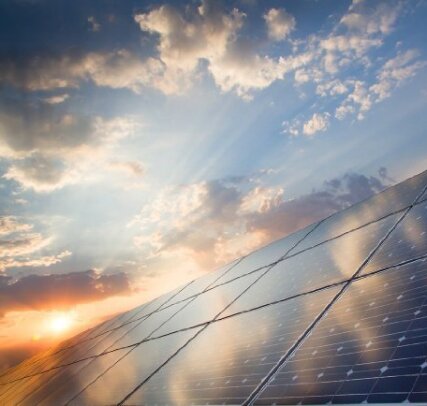 The sun rises over a solar panel array