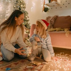 Mom and daughter opening Christmas presents together