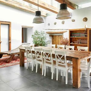 A dining area in a refurbished farmhouse with tile flooring