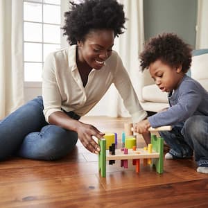 Mother and son sitting on the floor playing together