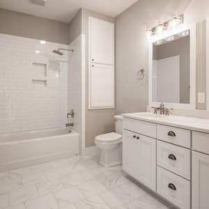 A white and beige modern bathroom with new shower/tub combo