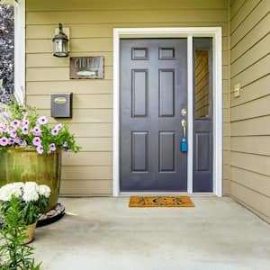 A blue front door on a house with concrete floor