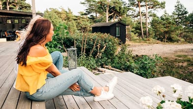 Two women sit on a deck