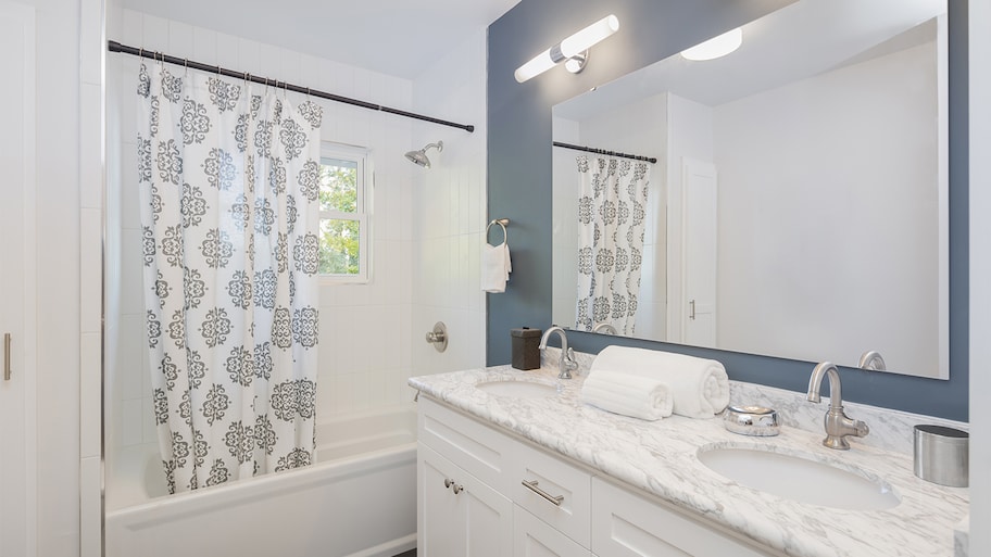 blue and white bathroom with large mirror