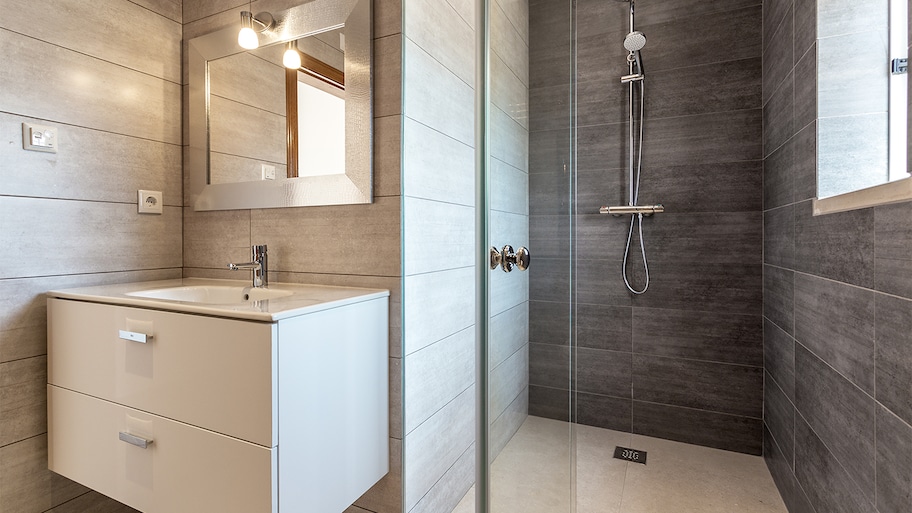 small beige and grey bathroom with drawers under sink