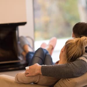 Young couple in front of fireplace