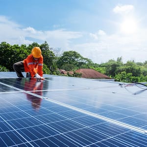 A technician installing new solar panels on a roof