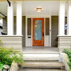 The exterior of a house with a wooden front door