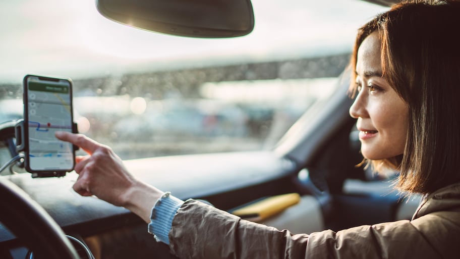 A young woman using a gps navigation system in her car