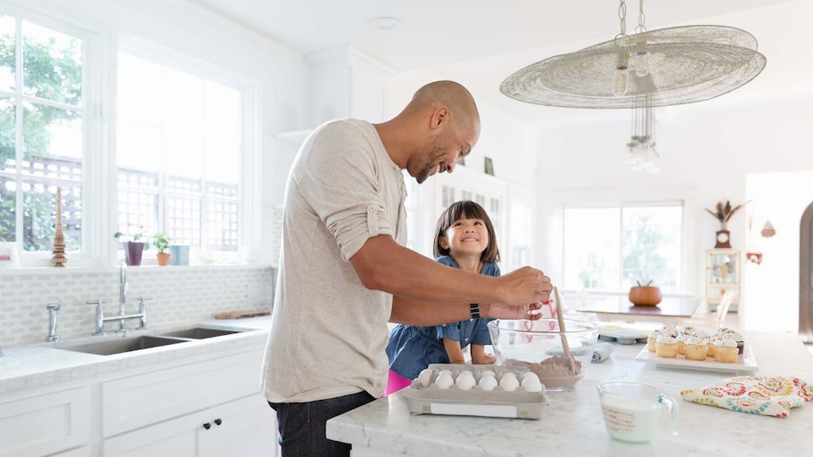 Father and daughter in the kitchen making food