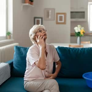 A woman calling a plumber for water leakage