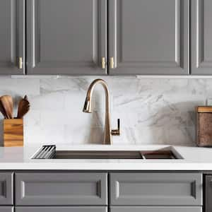 A kitchen with gray cabinets and an undermount sink