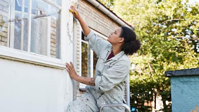 Woman sanding outside of house