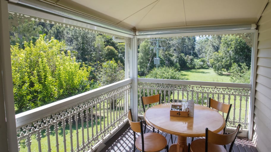 patio table and four chairs sit on screened in porch