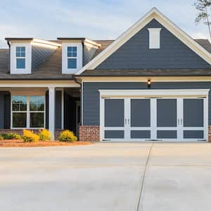 Small blue house with nice concrete driveway