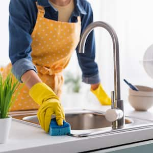 Person cleaning kitchen sink