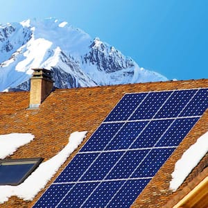 Solar panels on a snowy roof